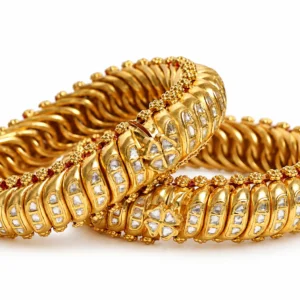 Ornate gold bangles featuring Polki-style stones and traditional detailing by SHA Jewelers