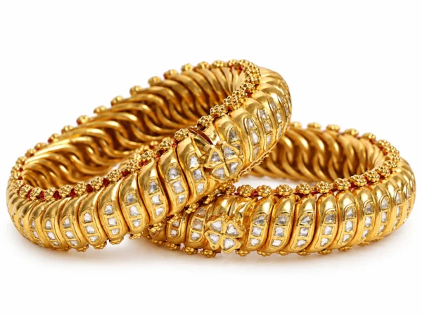 Ornate gold bangles featuring Polki-style stones and traditional detailing by SHA Jewelers