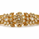 Ornate 22K gold Polki bangles with floral stone settings and traditional gold detailing by SHA Jewelers