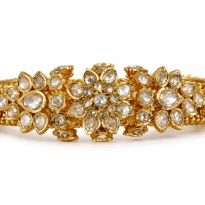 Ornate 22K gold Polki bangles with floral stone settings and traditional gold detailing by SHA Jewelers