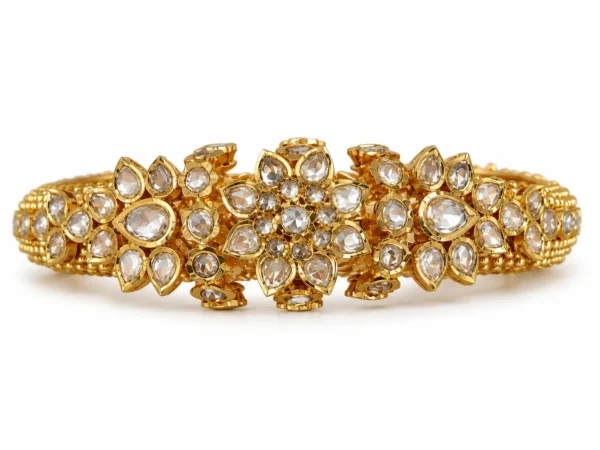 Ornate 22K gold Polki bangles with floral stone settings and traditional gold detailing by SHA Jewelers