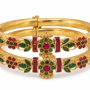 Traditional gold bangles with ruby-red and emerald-green stones by SHA Jewelers